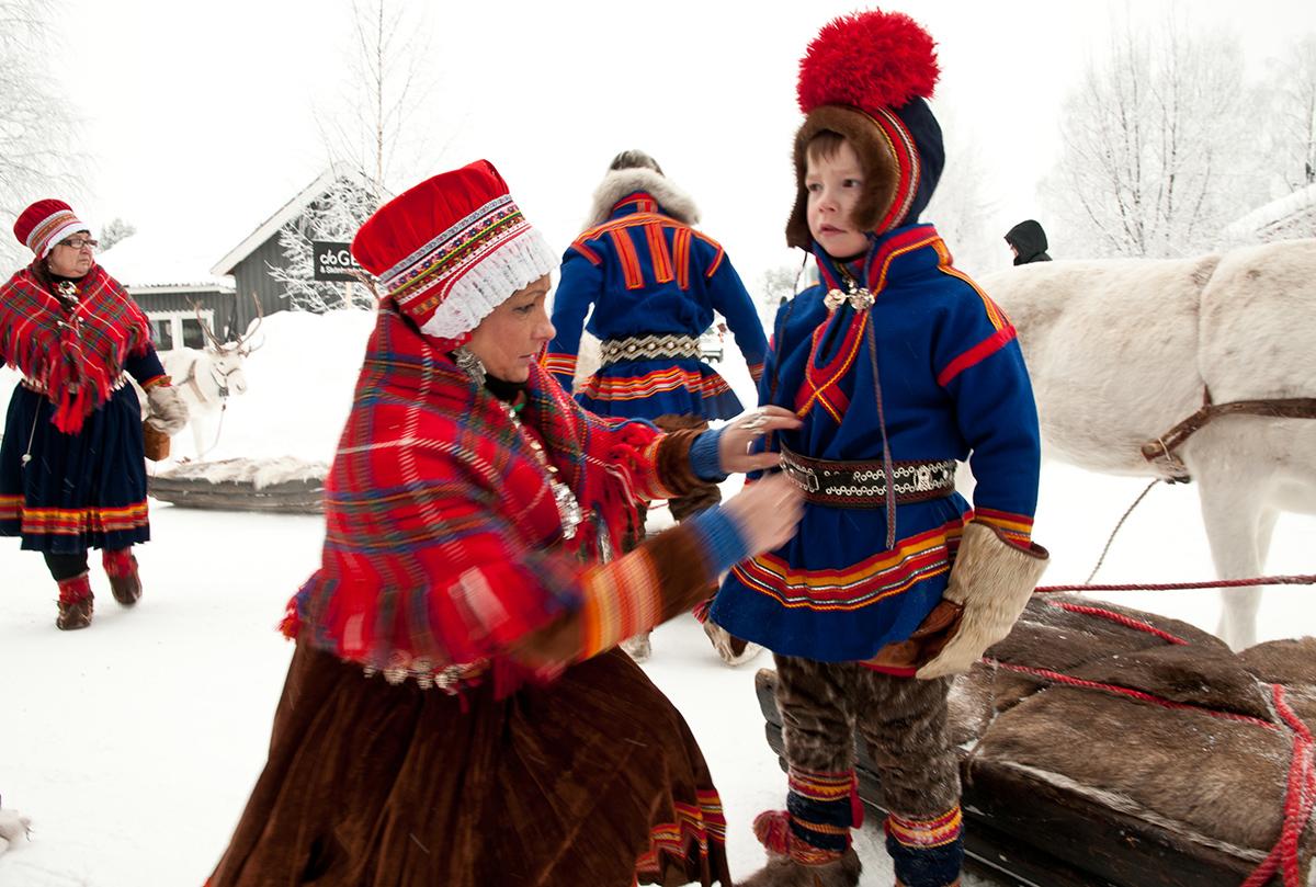 A family dressed in traditional Sami clothing.