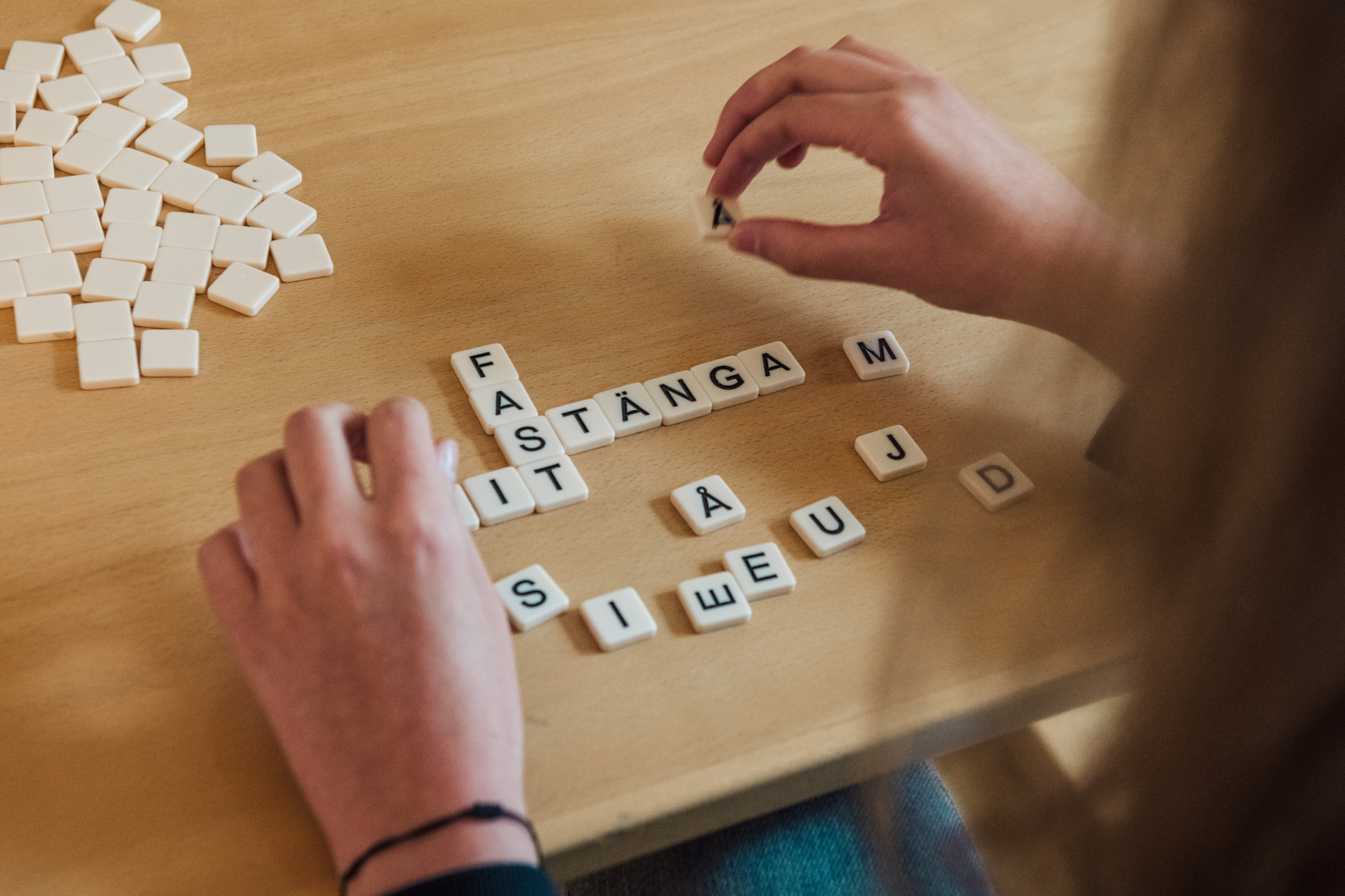 A person laying a word puzzle.