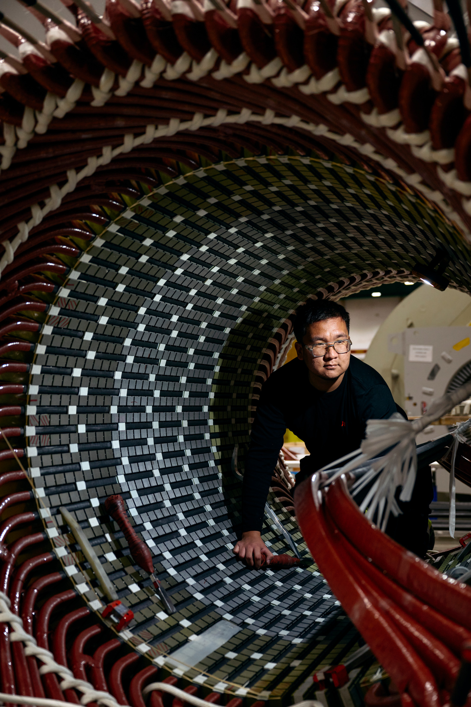 A worker inside a large drum.